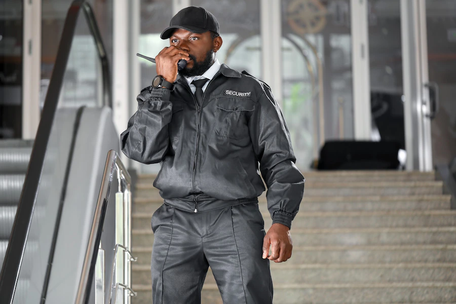 Security guard holding a walkie talkie.